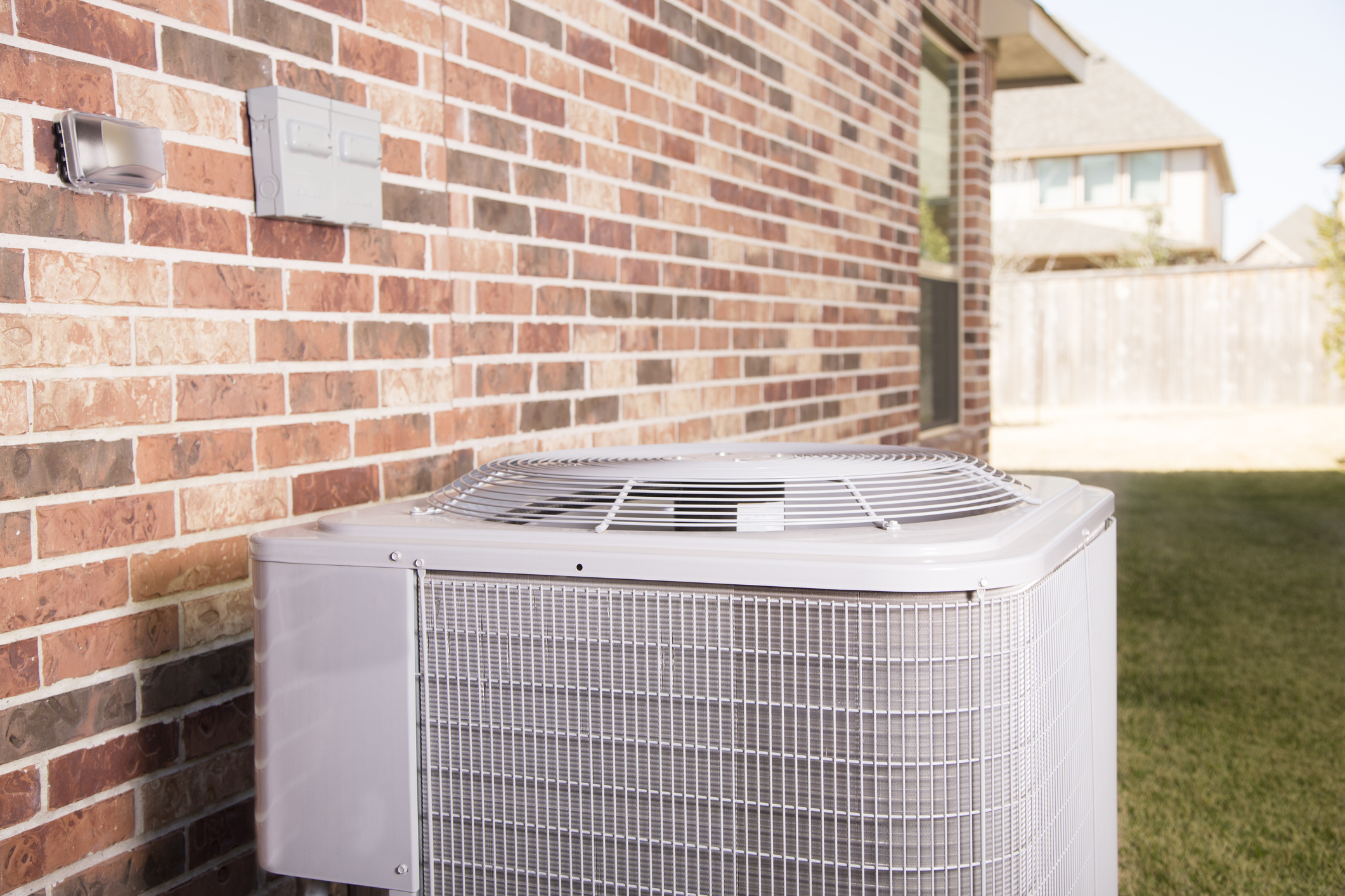 Air conditioner unit outside residential home. Summer